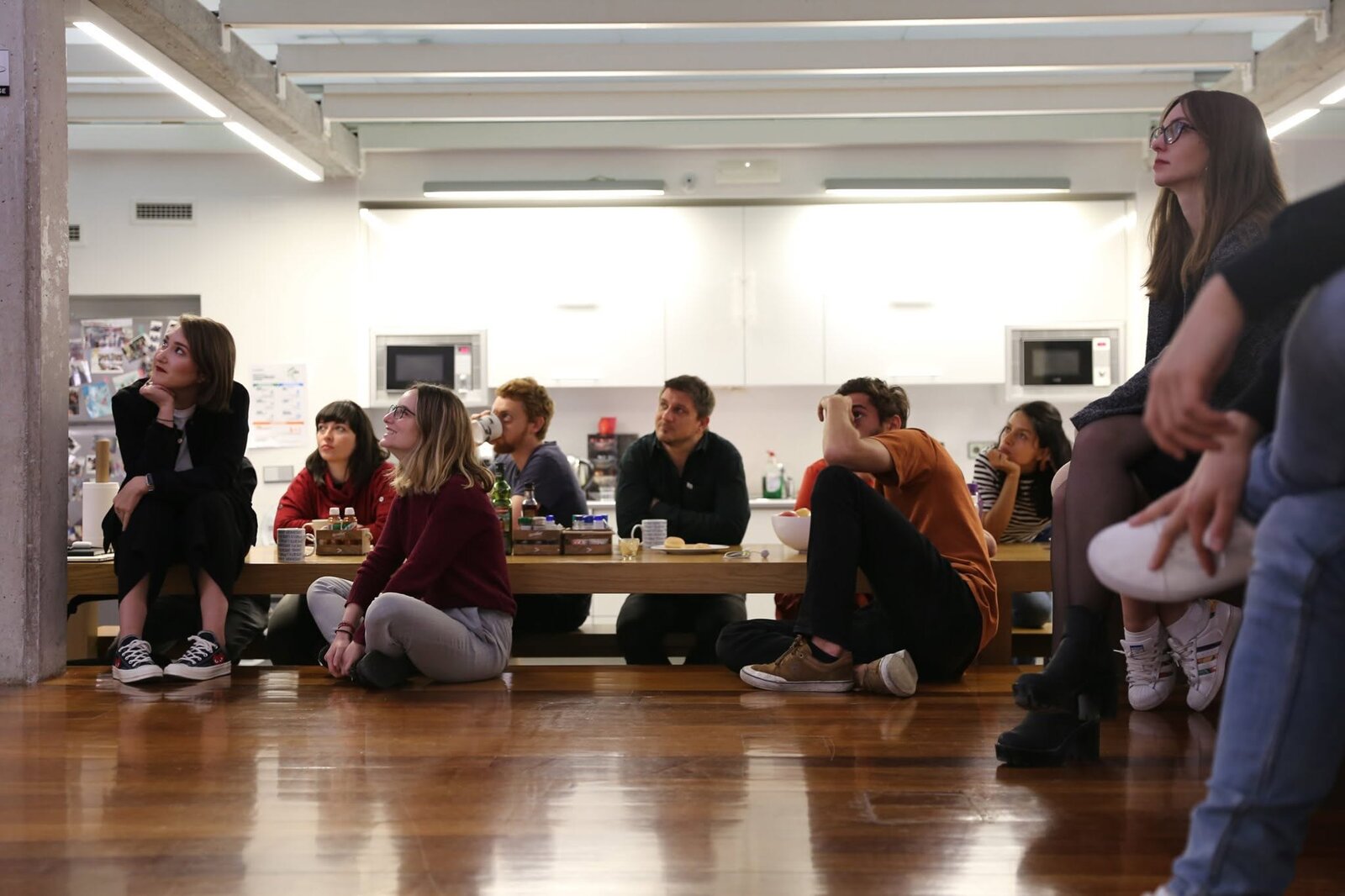 The Fjord Madrid team gathered around the office watching a presentation
