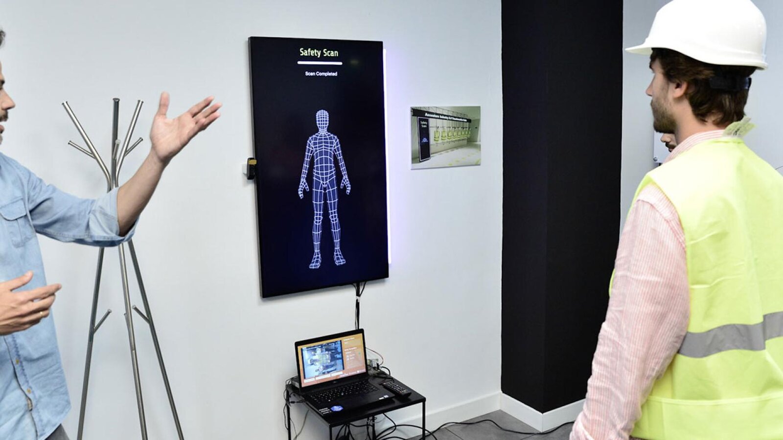 Wall display showing a completed safety scan, with an industrial worker nearby