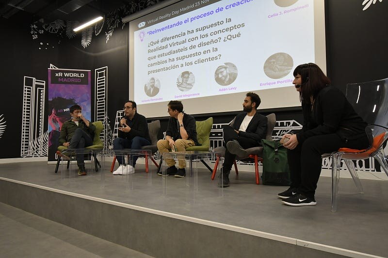 Celia moderating a table talks panel on stage